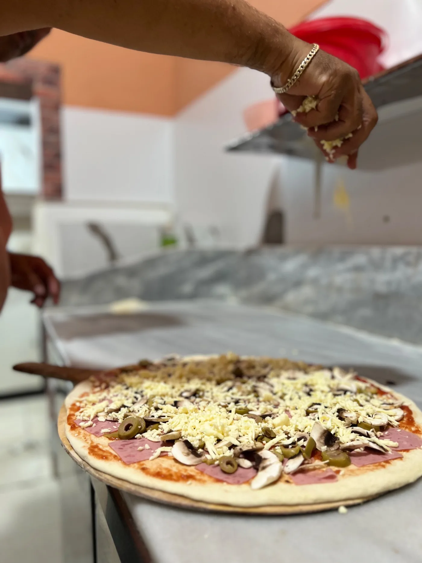 Pizza duke u përgatitur në Pizzeria Fejza në Bathore